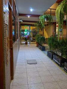 an empty hallway with potted plants in a building at Hotel Manantial in Churín