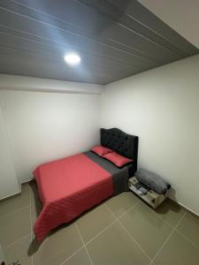 a bedroom with a red bed in a room at 302 Villamaria in Pereira +1 photo