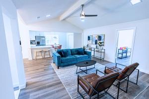 a living room with a blue couch and a table at Plano 40 miles to Fifa Stadium Private Pool Lux Home by Vacation Your Way in Plano +39 photos