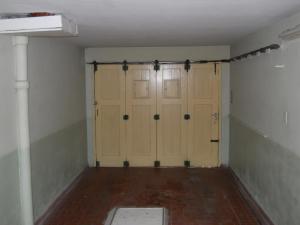 a room with two garage doors with a brick floor at Chalet céntrico super cómodo in Miramar