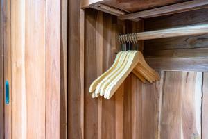 a wooden broom hanging on a wooden wall at Peaceful 1BR Private Villa in Sayan Ubud in Ubud
