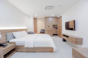 a hotel room with a bed and a television at Lumia Hotel in Ho Chi Minh City