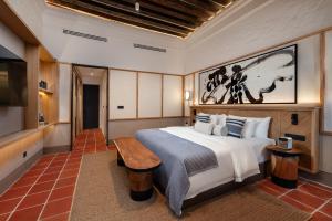 a hotel room with a bed and a television at Cheong Fatt Tze - The Qing Suites in George Town +56 photos