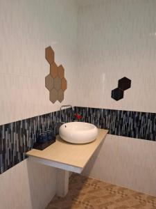 a bathroom with a white sink on a counter at Vang Vieng Moment Resort in Vang Vieng +11 photos