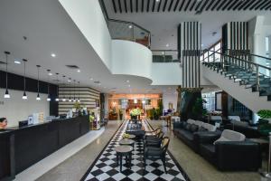 a lobby with couches and tables and a staircase at Pinnacle Lumpini Park Hotel in Bangkok +93 photos