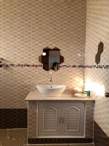 a bathroom with a sink and a mirror at Vang Vieng Moment Resort in Vang Vieng