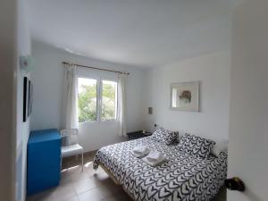 En eller flere senge i et værelse på Apartment Torre Soli Nou