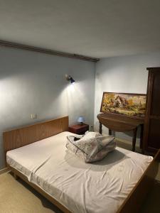 a bedroom with a bed and a piano at La Maison de Campagne in Estalane