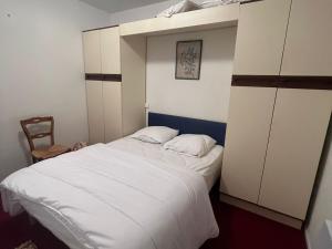 a bedroom with a large bed with white sheets at Appartement 4 Pers au Cœur de Super Besse - FR-1-814-142 in Super Besse