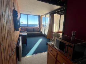 a living room with a television and a couch at Appartement 4 Pers au Cœur de Super Besse - FR-1-814-142 in Super Besse