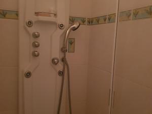 a shower with a hose in a bathroom at Appartement 4 Pers au Cœur de Super Besse - FR-1-814-142 in Super Besse