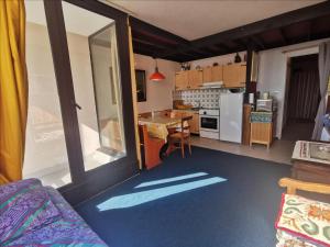 a room with a kitchen with a table and a kitchen at Appartement 4 Pers au Cœur de Super Besse - FR-1-814-142 in Super Besse