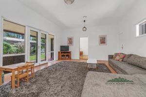 a living room with a couch and a table at Home at Haverfield in Echuca +8 photos