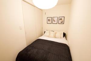 a small bedroom with a bed in the corner at Chill Place 125 Kameari in Tokyo