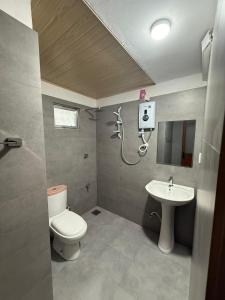 a bathroom with a toilet and a sink at Goalma Family Holiday Resort & Restaurant in Anuradhapura