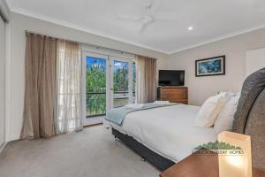 a bedroom with a bed and a large window at Campaspe Central - Your Central Echuca Escape! in Echuca