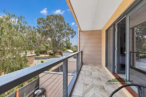 a balcony with a view of the ocean from a house at Campaspe Central - Your Central Echuca Escape! in Echuca