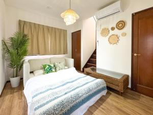 a bedroom with a bed and a potted plant at #43 Sajima nagi in Yokosuka