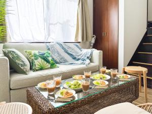 a living room with a table with plates of food on it at #43 Sajima nagi in Yokosuka