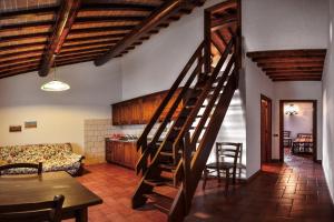 a living room with a spiral staircase in a house at Podere Trieste in Cialabrone