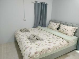 a bed with pillows and towels on top of it at Baan Boy in Ko Kood