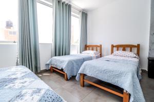 Ένα ή περισσότερα κρεβάτια σε δωμάτιο στο Cerro Azul Alojamiento