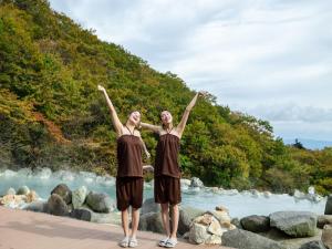 two people standing next to a body of water at YU-FURI Nasu-Takao Onsen Lodge in Nasu
