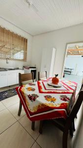 a kitchen with a table with an orange on top of it at Bembella casa em Balneario Camboriu in Balneário Camboriú +6 photos