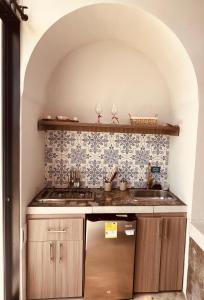 a kitchen with a sink and a stove at Majestic View House in Curití