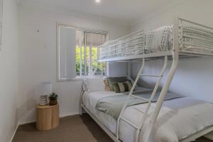 Ένα ή περισσότερα κρεβάτια σε δωμάτιο στο The Beach Bach