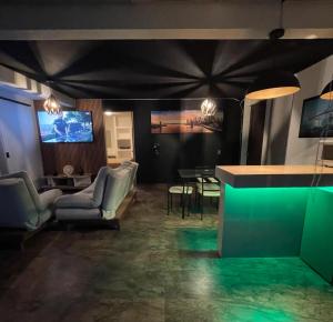 a living room with chairs and a tv on a wall at PH 41 Metepec in Toluca