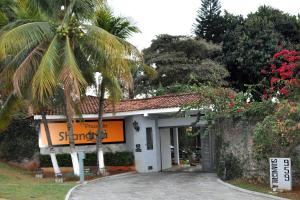 un edificio con una palmera delante de él en Pousada Shangrila, en Ribeirão Preto