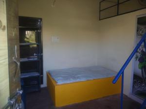 a small room with a bed and a window at mithra house in Khammam