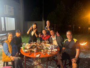 a group of people sitting around a table at 陌野輕旅民宿 in Xiulin