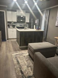 cocina con armarios blancos, sofá y mesa en Bannock Manor, en Memphis