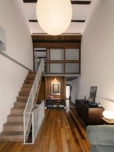 a living room with stairs and a large light fixture at Cheong Fatt Tze - The Townhouses in George Town