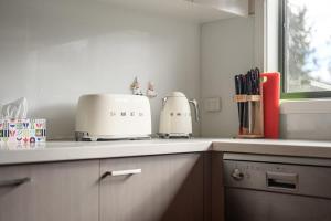 a kitchen counter with two toasters on top of it at Welcome home Burwood in Burwood