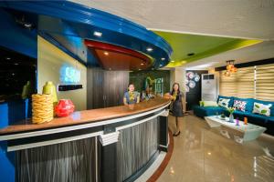 two people standing at a bar in a restaurant at 950 Condotel in Angeles