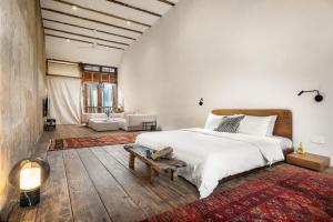 a bedroom with a large bed and a living room at Cheong Fatt Tze - The Townhouses in George Town