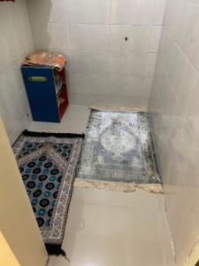 a bathroom with a shower with a tile floor at De Adisucipto Homestay Syariah 2 in Ngadipuro +6 photos
