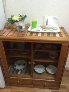 a wooden table with dishes on top of it at Rainbow House in Osaka