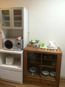 a toy kitchen with a microwave and a counter at Rainbow House in Osaka