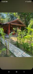 a pavilion in a garden with a stone walkway at Bang risskee home stay2 in Ko Yao Noi