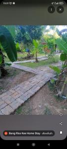 a picture of a stone pathway in a garden at Bang risskee home stay2 in Ko Yao Noi