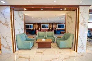a lobby with chairs and a table and a mirror at فندق جوهرة المقام الحمراء in Jeddah