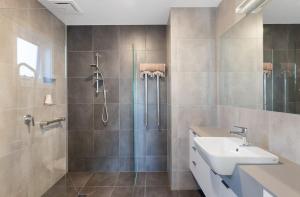 a bathroom with a shower and a sink at EcoHaven Beach Retreat in Cape Paterson