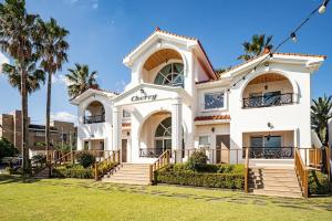 a white house with palm trees in front of it at Stay Cherry in Namwon