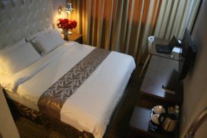 Postel nebo postele na pokoji v ubytování Ritz Garden Hotel Manjung