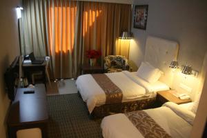 Postel nebo postele na pokoji v ubytování Ritz Garden Hotel Manjung