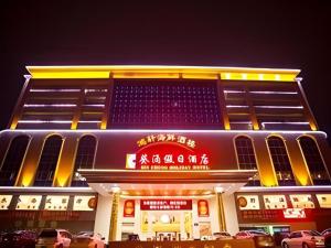 a building with signs on the side of it at Kui Chong Holiday Hotel in Tongshi